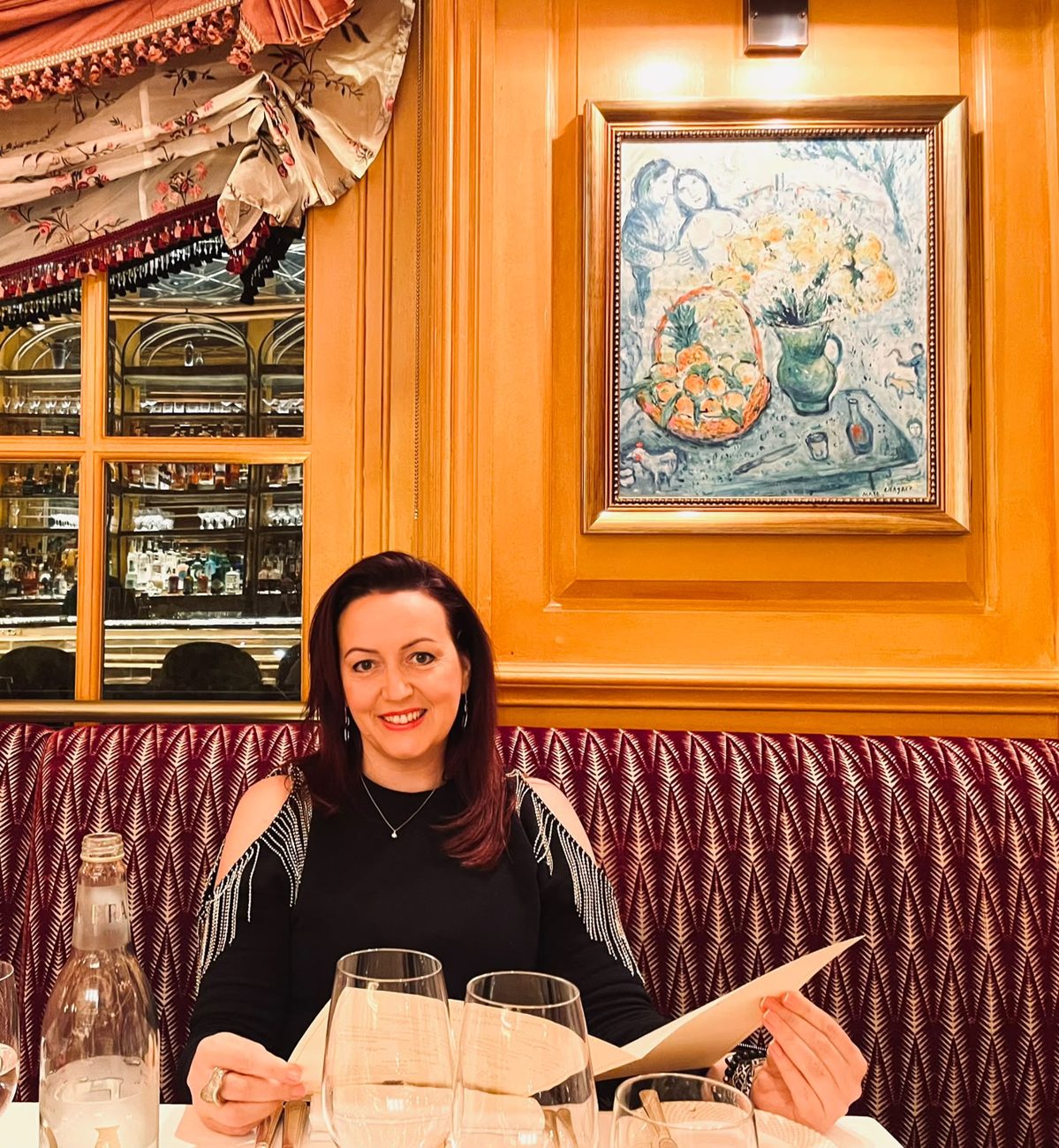 Mariann Beke, smiling, at a restaurant table